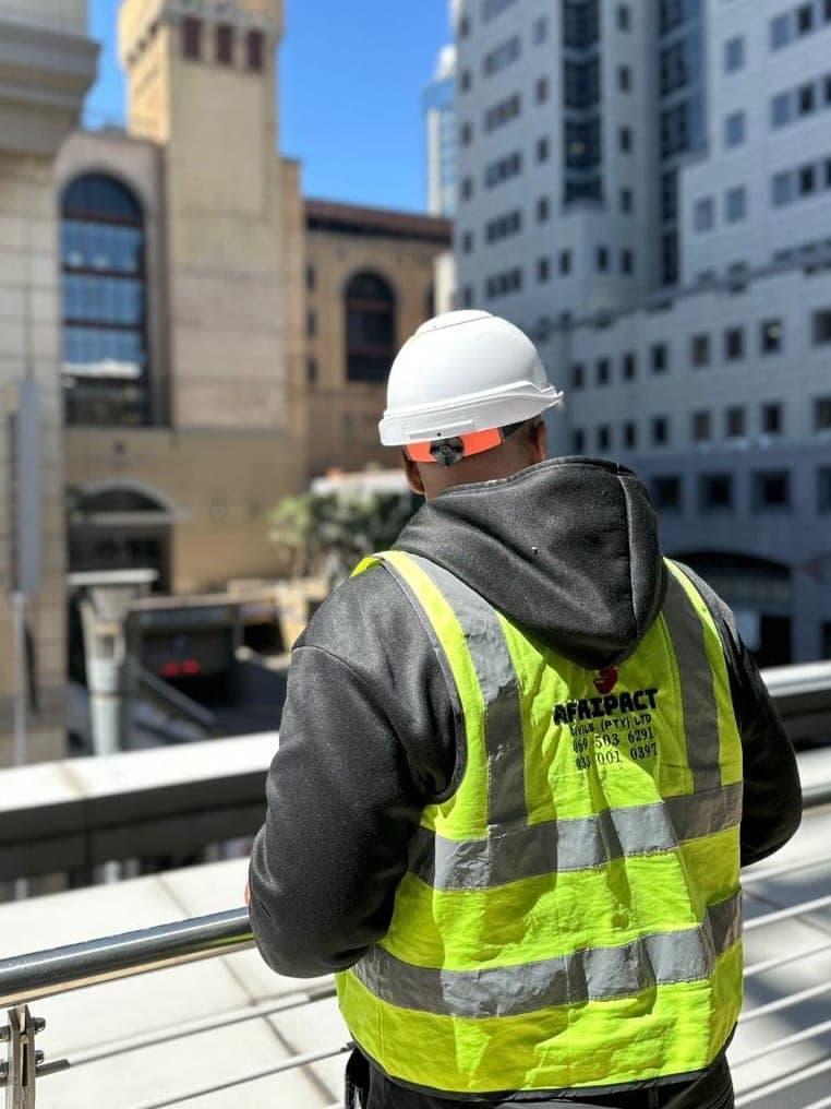 Afripact site inspection on an elevated walkway overlooking a commercial site