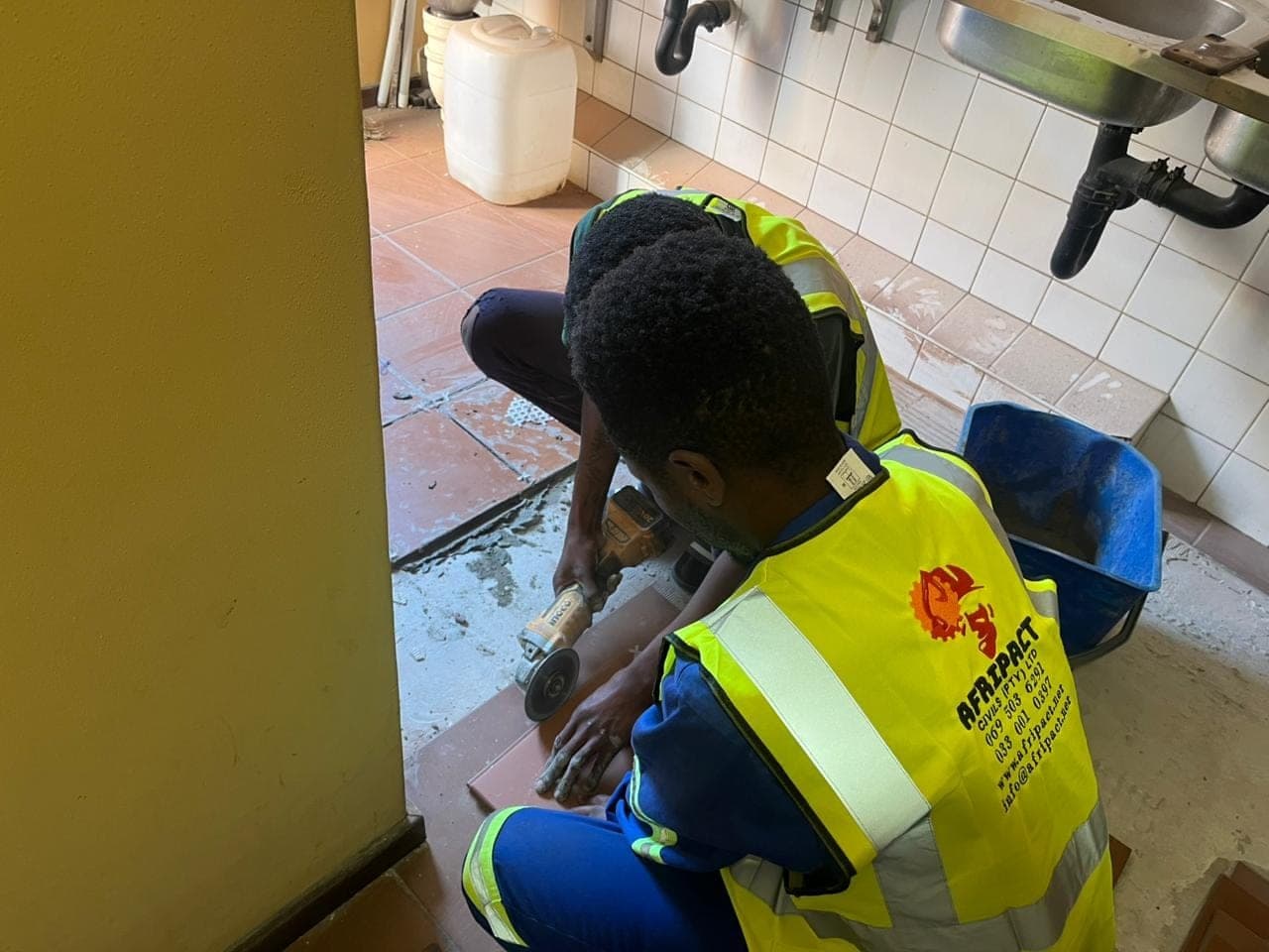 Removing damaged tile during a commercial ablution retiling job